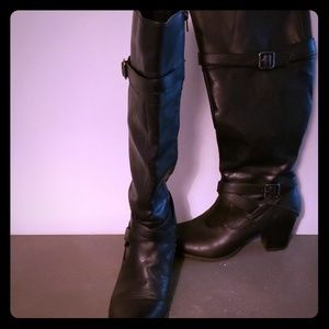 Black heeled strap and zipper knee high boots